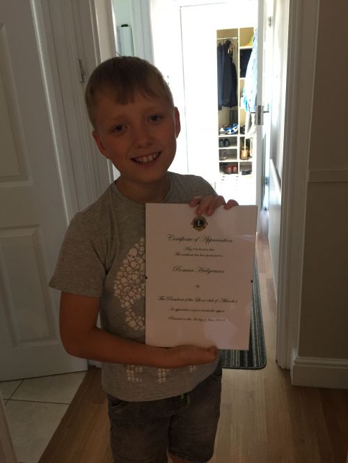 Roman with his appreciation certificate